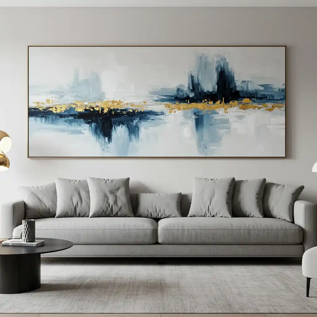A long wall decorating idea showing a large, oversized abstract painting hanging above a sofa.